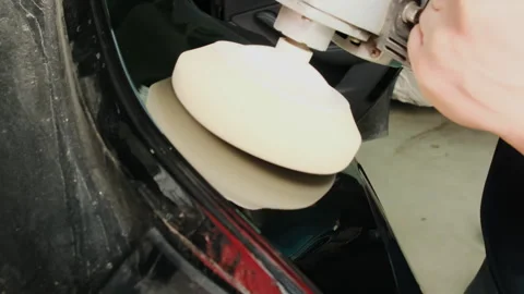 Guy removes unevenness on surface of car in hall during shift Stock Footage 316184751