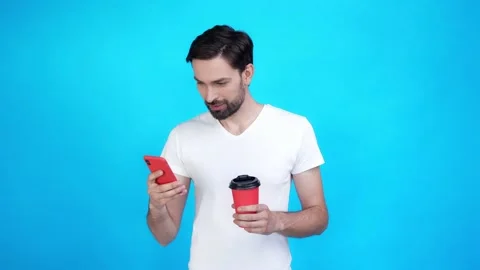 Guy rest chill drink latte use smart phone isolated on blue color background Stock Footage 165403763