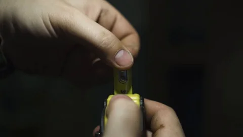 The guy reveals a measuring building ruler in garage Stock Footage 108501184