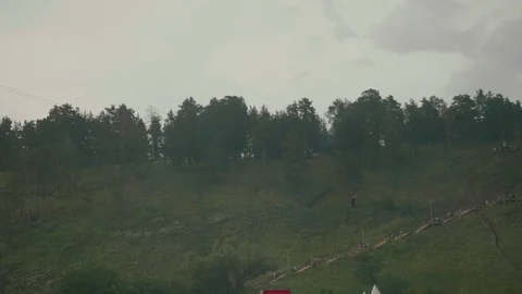 Guy ride zip line and makes video on smart phone Stock Footage 78729372