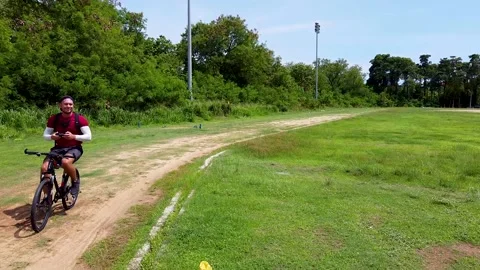 The guy rides a bicycle without hands, filming himself with a drone, front view Stock Footage 171391664