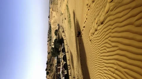The guy rides on the desert dunes on a board Stock Footage 238544562