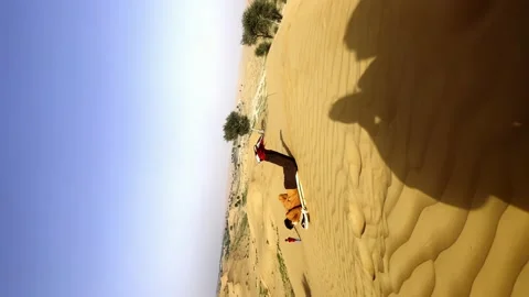 The guy rides on the desert dunes on a board Stock Footage 239177615
