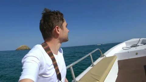 A guy rides a motorboat in the open ocean filming himself Stock Footage 236371738