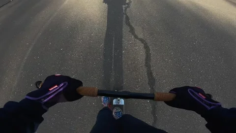 A guy rides a scooter, a boy performs a trick on a scooter, a camera on a helmet Stock Footage 172089856