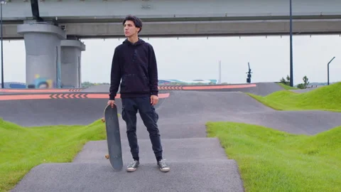 Guy rides skateboard on asphalt waves. Skatepark Video stock 163539331