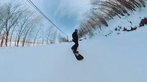 A guy rides a snowboard and stops in front of a girl, shooting on a 360 camera Stock Footage 169144798