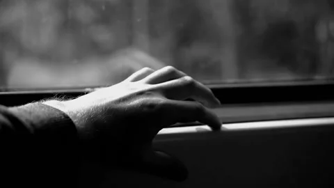 A guy rides a train and taps his fingers on the window sill. Nice close-up. Stock Footage 134046326