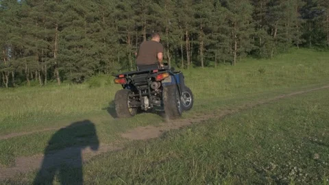 The guy rides very fast on a quad motorcycle Stock Footage 291732906