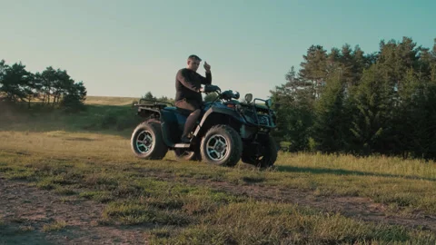 The guy rides very fast on a quad motorcycle. Stock Footage 291734470