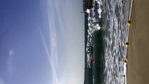 A guy rides the waves, a man trains to surf Stock Footage 238686609