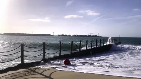 A guy rides the waves, a man trains to surf Stock Footage 250969056