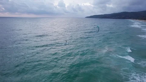 A guy rides on the waves of ocean on kitesurfing Video stock 246918206