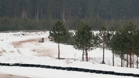The guy is riding an ATV on a snow-covered road in winter Video stock 84955926