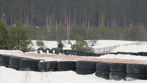 The guy is riding an ATV on a snow-covered road in winter Stock Footage 84956073