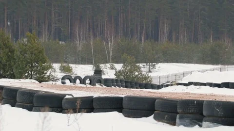 The guy is riding an ATV on a snow-covered road in winter Vídeos de archivo 84956343