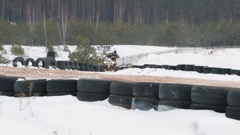 The guy is riding an ATV on a snow-covered road in winter Stock Footage 84956390