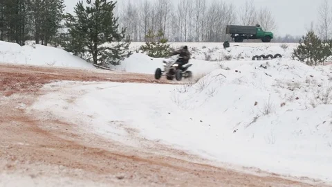 The guy is riding an ATV on a snow-covered road in winter 動画素材 84958068