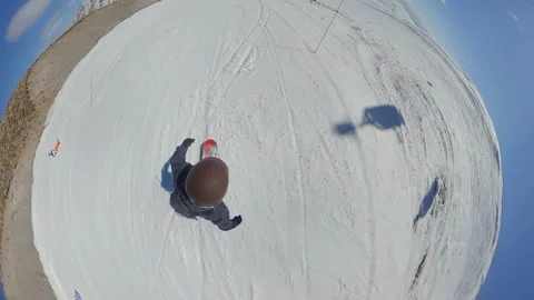 Guy riding his snowboard down the mountain on ski resort. 360VR: view from above Stock Footage 149516865