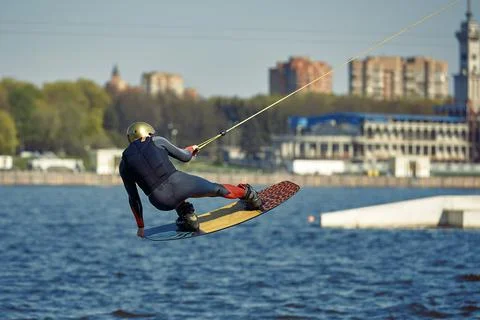 The guy is riding a wakeboard on the river. Active and Extreme Sports Stock Photos