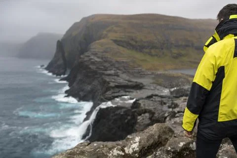 Guy on rocky seashore Foto stock