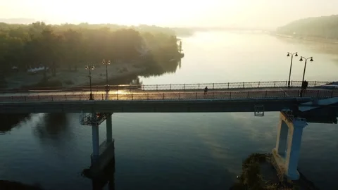Guy on roller skates rides on the bridge in the early morning Stock Footage 185571831