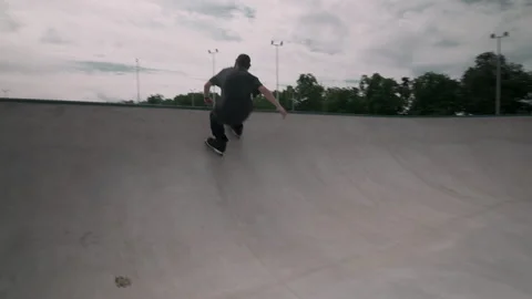 The guy on roller skates in the skatepark does tricks. Video stock 199838975