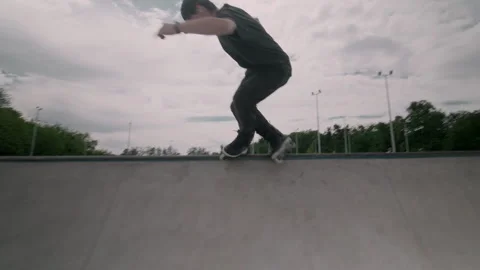 The guy on roller skates in the skatepark does tricks. Stock Footage 199838982