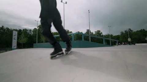 The guy on roller skates in the skatepark does tricks. Stock Footage 199839001