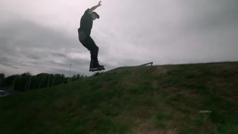 The guy on roller skates in the skatepark does tricks. Stock Footage 199839023