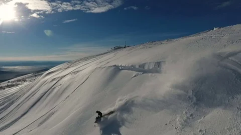 Guy rolling around and jumping on a snowmobile Video stock 81056315
