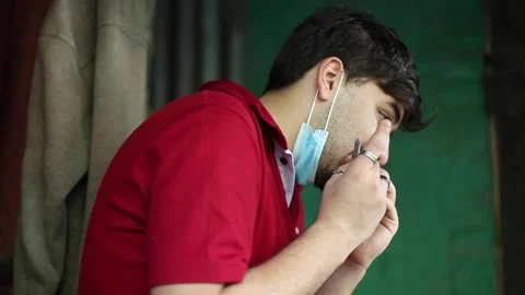 Guy rolling a marijuana joint Stock Footage 144825046