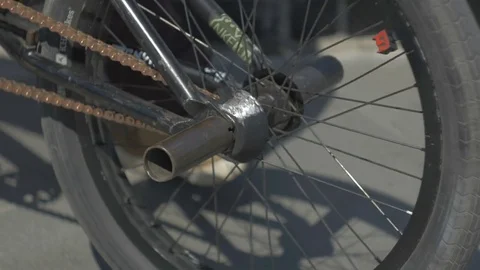 Guy rolls the bike on the ground Stock Footage 81810551
