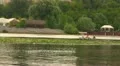 guy rolls girl by the boat down the river HD Footage