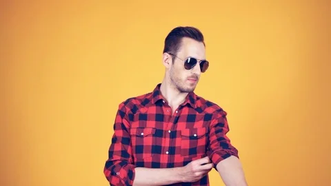 The guy rolls his sleeve red shirt Stock-Footage 74953937