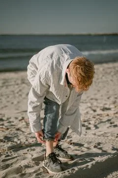 Guy rolls up jeans Stock Photos