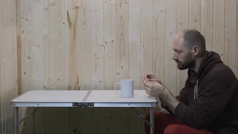 The guy in the room opens a bag of pills, swallows them and drinks water Stock Footage 119875531