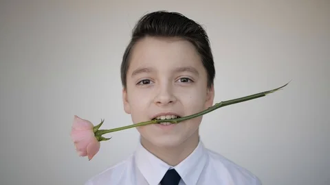 The guy with the rose in his teeth winks his eye Stock-Footage 128047079