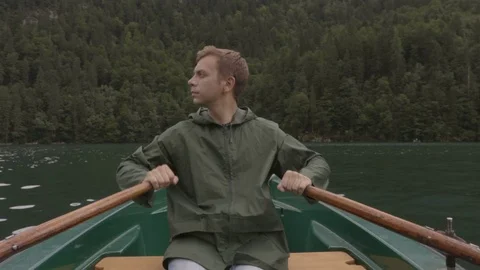 Guy is rowing on the boat between the wild nature Stock Footage 83628414
