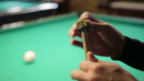 The guy rubs the cue for playing Billiards Stock Footage 81001523
