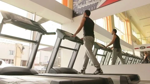 The guy is running along the treadmill Stock Footage 73989005