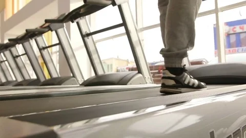 The guy is running along the treadmill Stock Footage 73989012