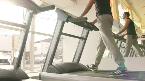 The guy is running along the treadmill Stock Footage 73989046