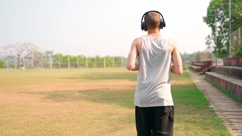 A guy running around the stadium, view from the back. Slow motion video. Stock Footage 231336638