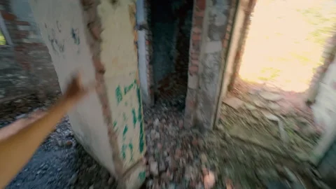 A guy is running away from danger in an abandoned building. Stock Footage 313359393