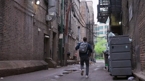Guy running away, trying to escape. bad part of town, slums. robbers drugs Stock Footage 281137810
