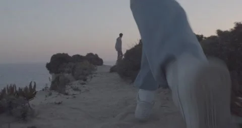 Guy running on beach cliff in the sunset, tracking shot, Portugal Stock Footage 236485207