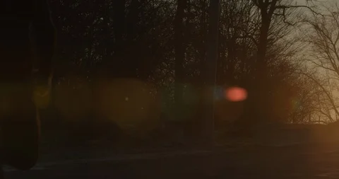 A guy is running down the road at dawn. Cold weather. 4k Stock Footage 123784007