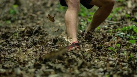 The guy is running down a steep hill while participating in an ocr race Stock Photos