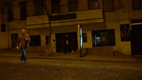 Guy runs across the road and the car stops in time Stock Footage